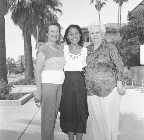 Portrait photo of a smiling girl w/ family
