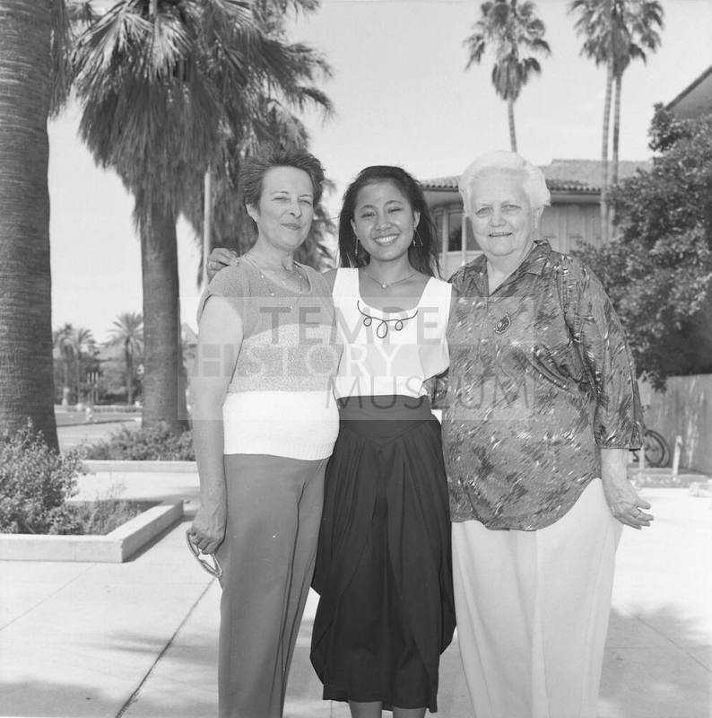 Portrait photo of a smiling girl w/ family