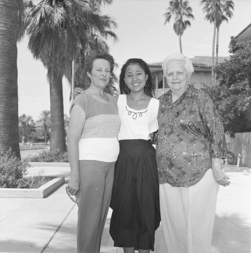 Portrait photo of a smiling girl w/ family