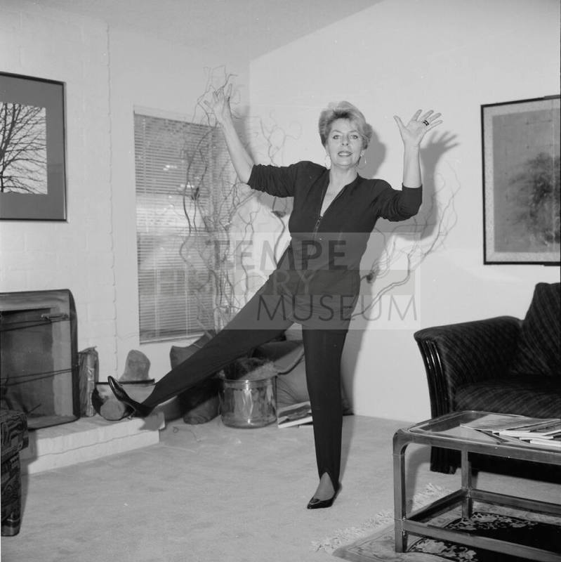 Middle Aged woman dancing in her home
