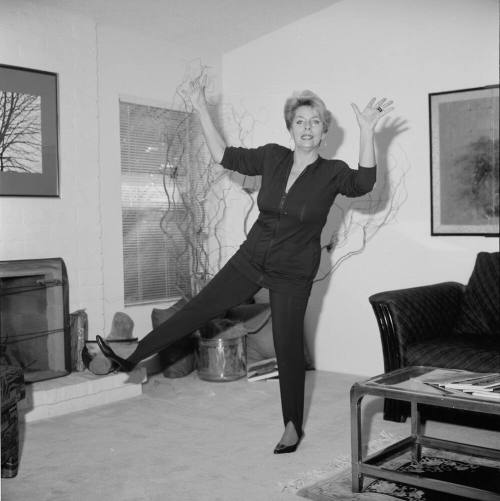 Middle Aged woman dancing in her home