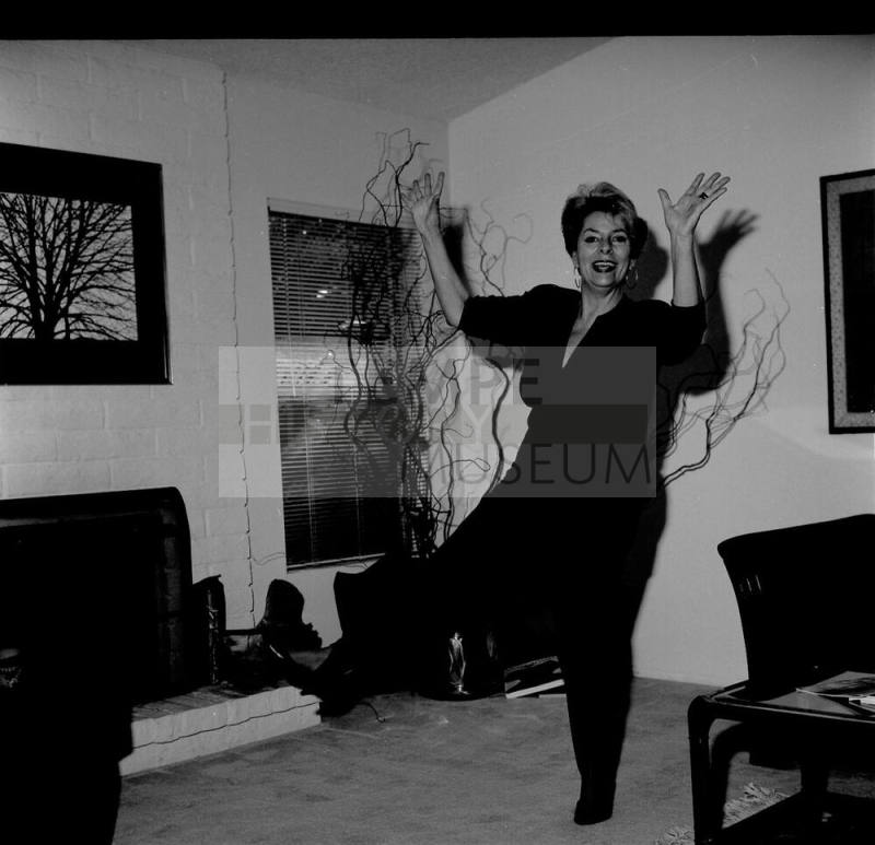 Middle Aged woman dancing in her home