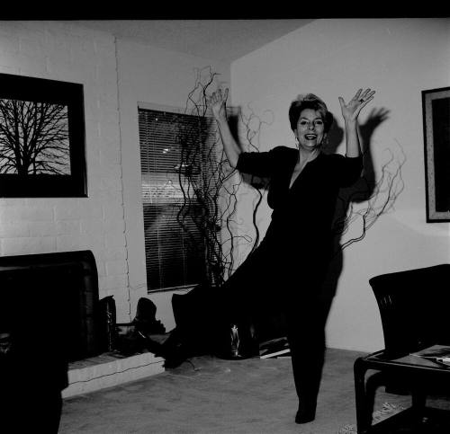 Middle Aged woman dancing in her home
