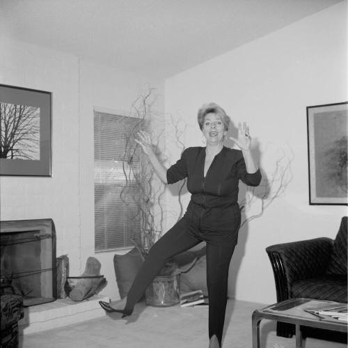 Middle Aged woman dancing in her home