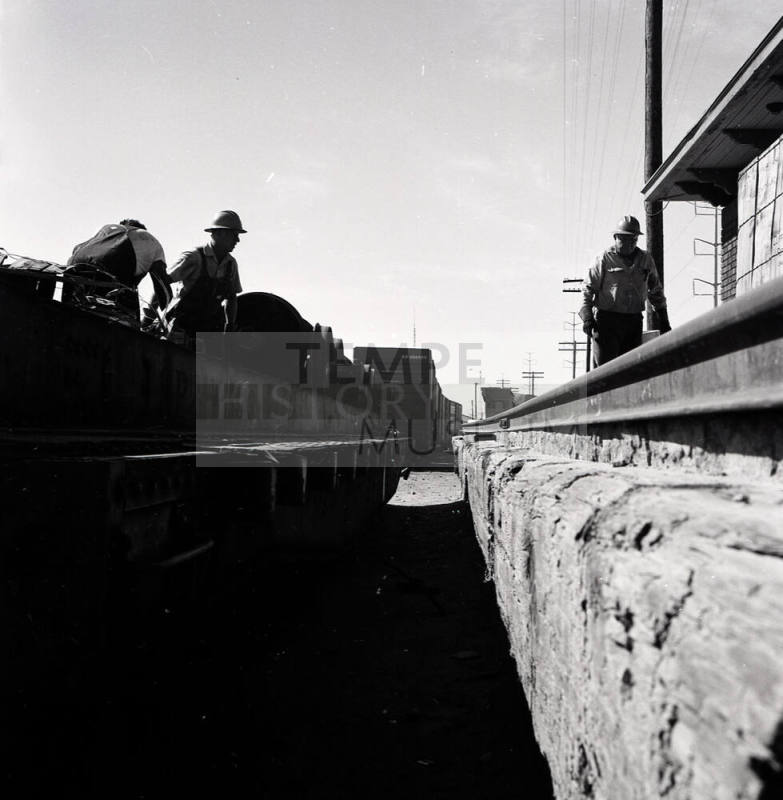 Freight transfer between flat car and Tempe Depot loading dock