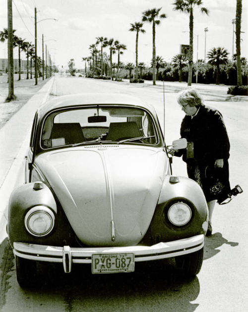 Jan Young in legendary raincoat by her VW bug.