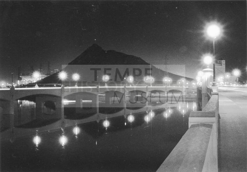 Tempe Town Lake with Mill Avenue Bridge, flour mill, and Tempe Butte in background.