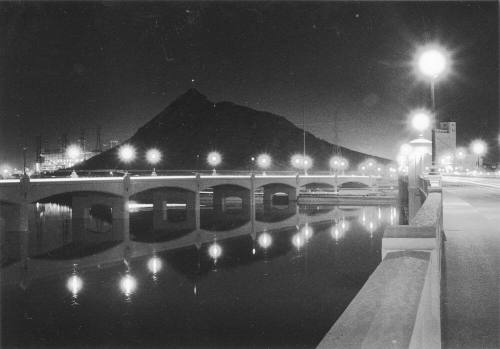 Tempe Town Lake with Mill Avenue Bridge, flour mill, and Tempe Butte in background.