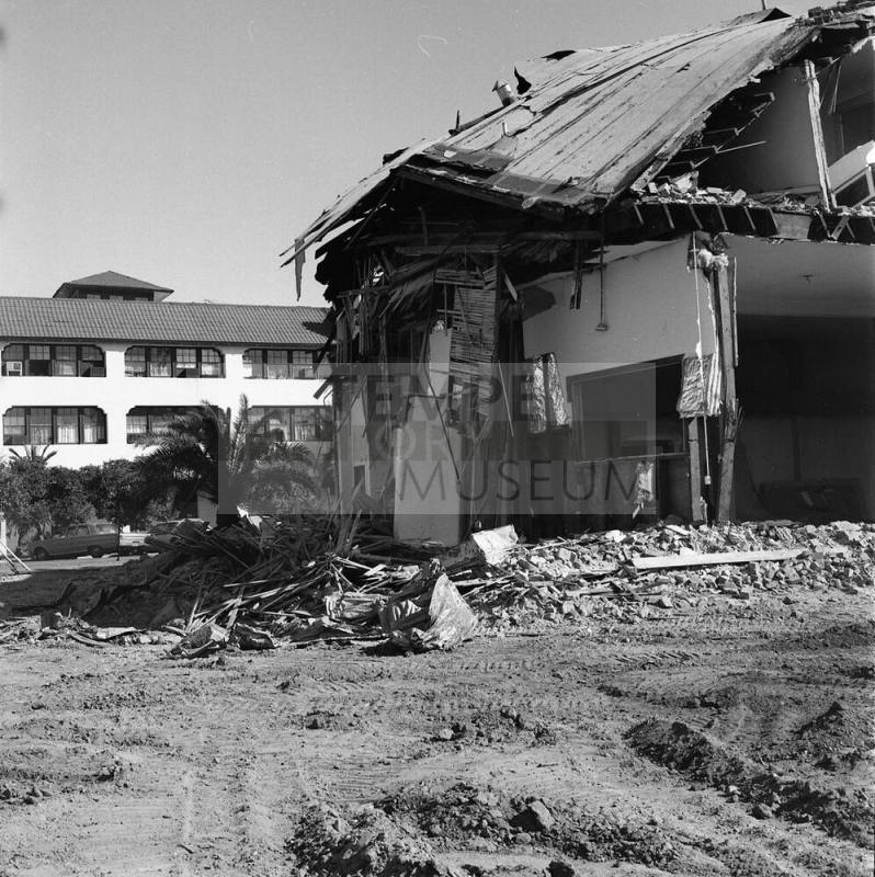 Partially demolished building with Casa Loma Building in the background