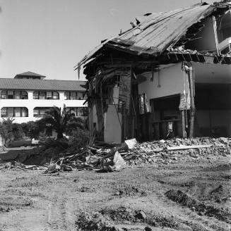 Partially demolished building with Casa Loma Building in the background