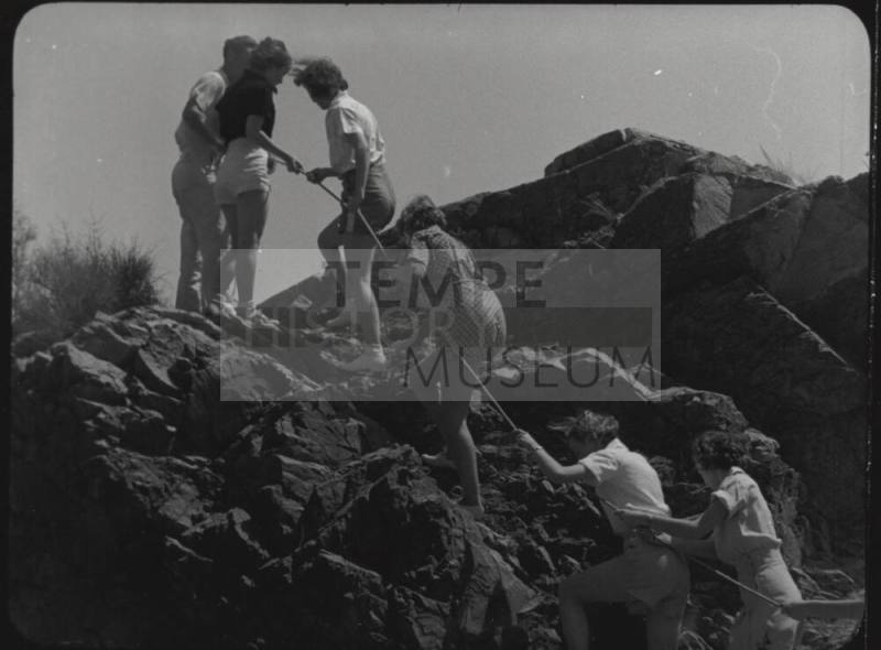 Black and white Photograph: group of coeds climbing Tempe Butte