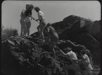 Black and white Photograph: group of coeds climbing Tempe Butte