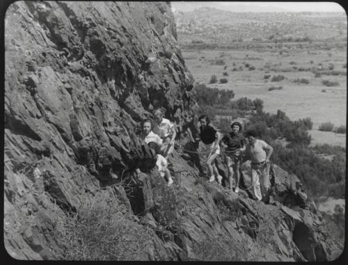 Black and white photograph: group of coeds climbing Tempe Butte