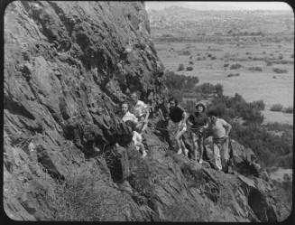 Black and white photograph: group of coeds climbing Tempe Butte