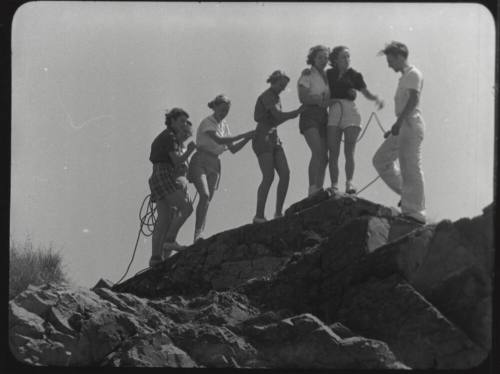 Black and whtie photograph: group of coeds climbing Tempe Butte