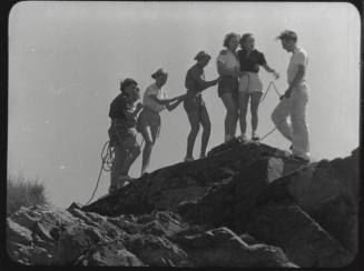 Black and whtie photograph: group of coeds climbing Tempe Butte