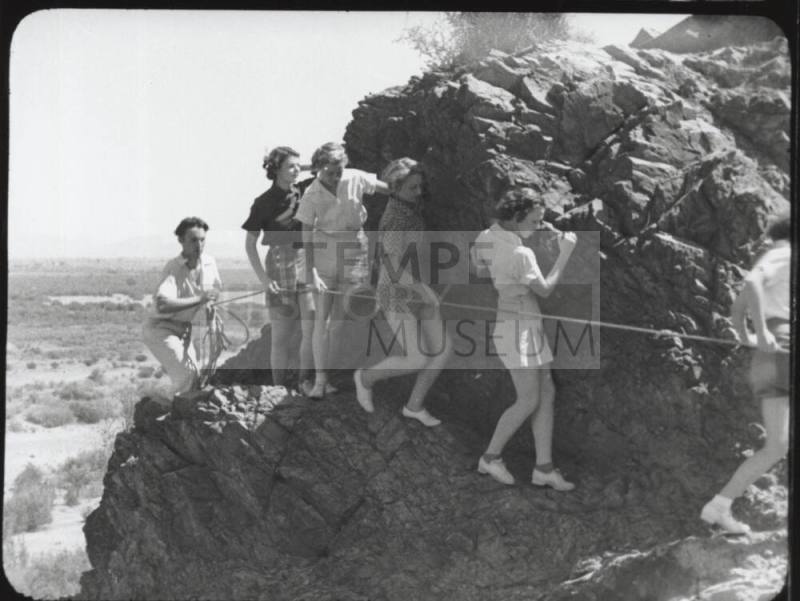 Black and white photograph: group of coeds climbing Tempe Butte