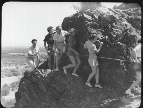 Black and white photograph: group of coeds climbing Tempe Butte