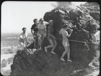 Black and white photograph: group of coeds climbing Tempe Butte