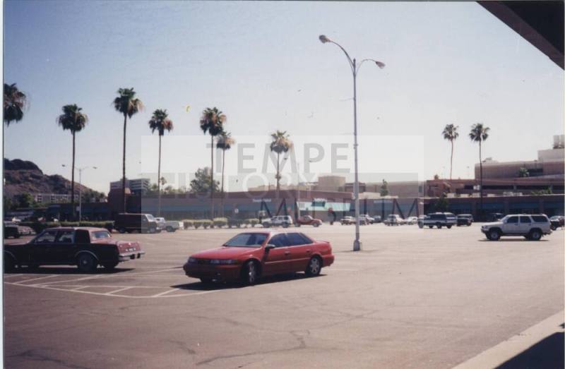 Color print of Tempe Center stores and parking lot, looking east