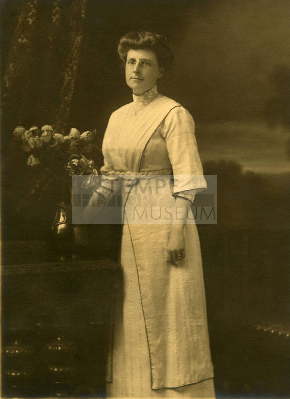 Woman standing near flowers