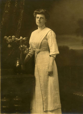 Woman standing near flowers