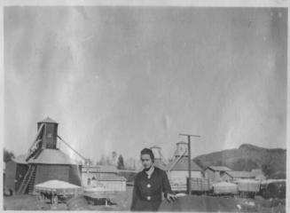 Girl standing behind cotton farm