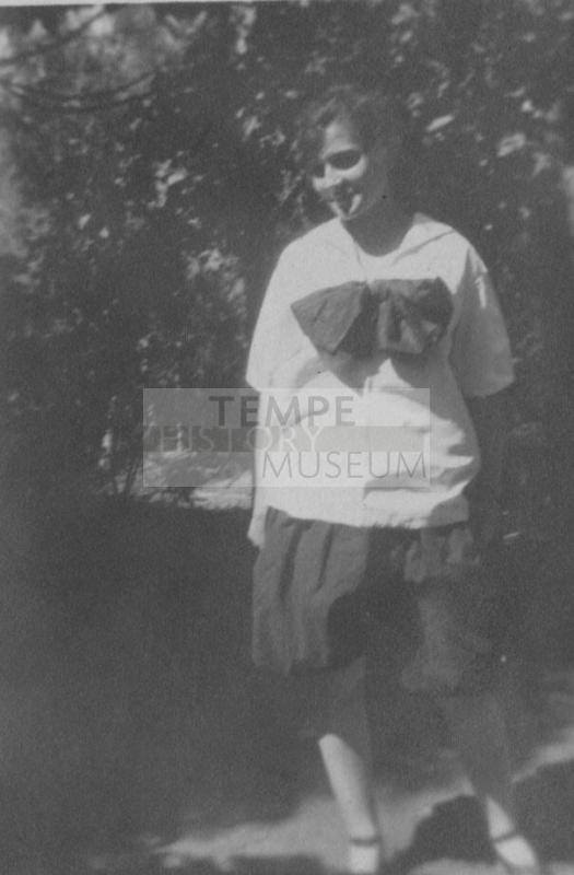 Girl in white shirt standing