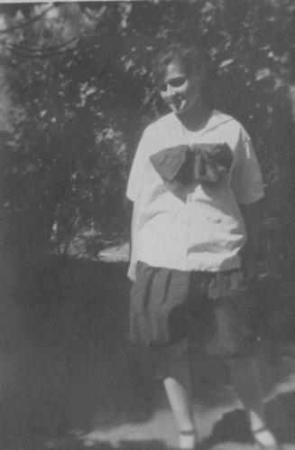 Girl in white shirt standing