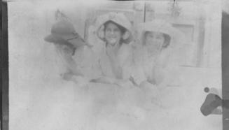 Three girls wearing hats