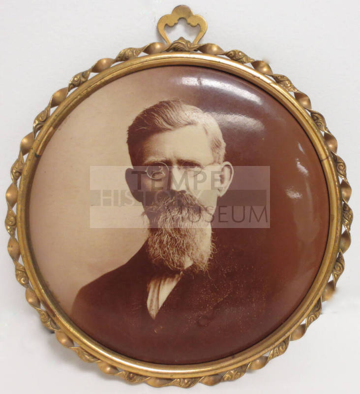 Portrait of man wearing glasses on button with frame