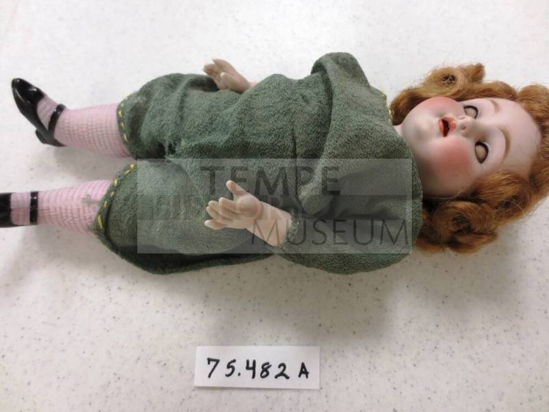 Doll in green jump suit