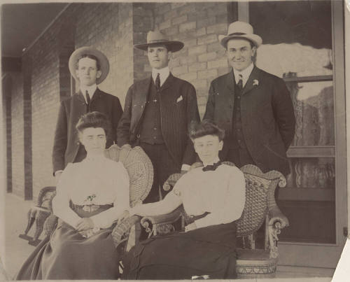 Group of Three Men Standing, Two Women Seated