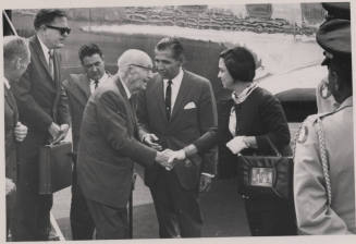 Carl shakes hands with a woman next to an Air Force plane