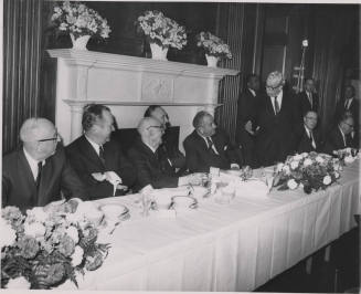 Senator Hayden and President Johnson, among others, seated at table