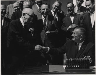 Carl Hayden Shakes Hand of seated L. B. Johnson Signing a Bill