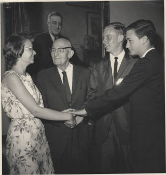 Senator Hayden clasps hands with young adults