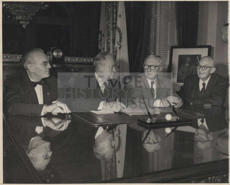 Four Men seated at Glass-Topped Desk, Hayden at Eight