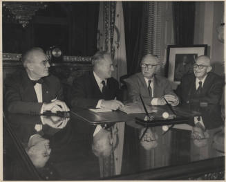 Four Men seated at Glass-Topped Desk, Hayden at Eight