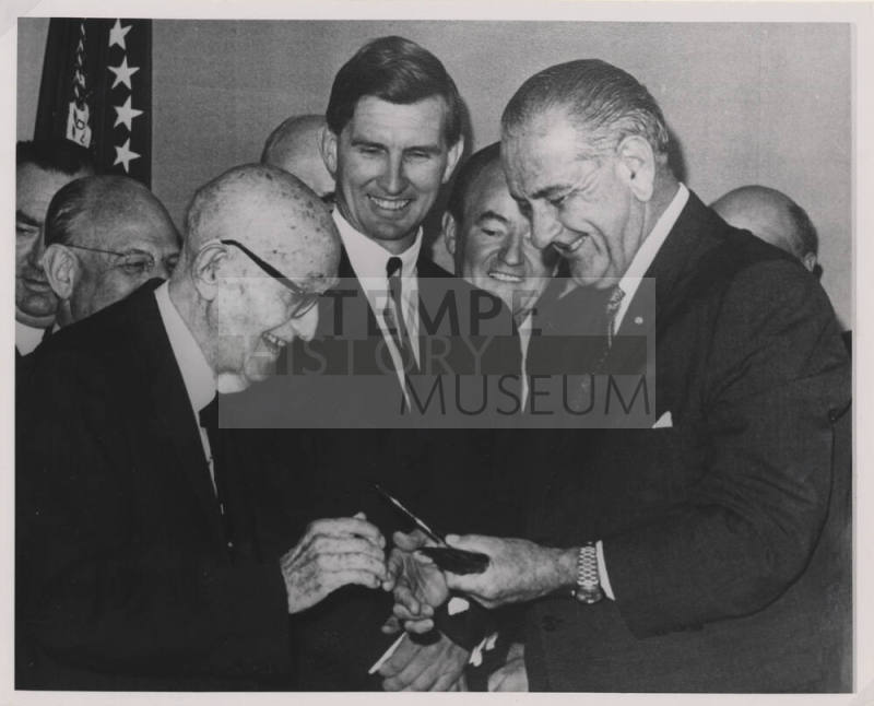 Group of Men with L. B. Johnson giving a Pen to Hayden