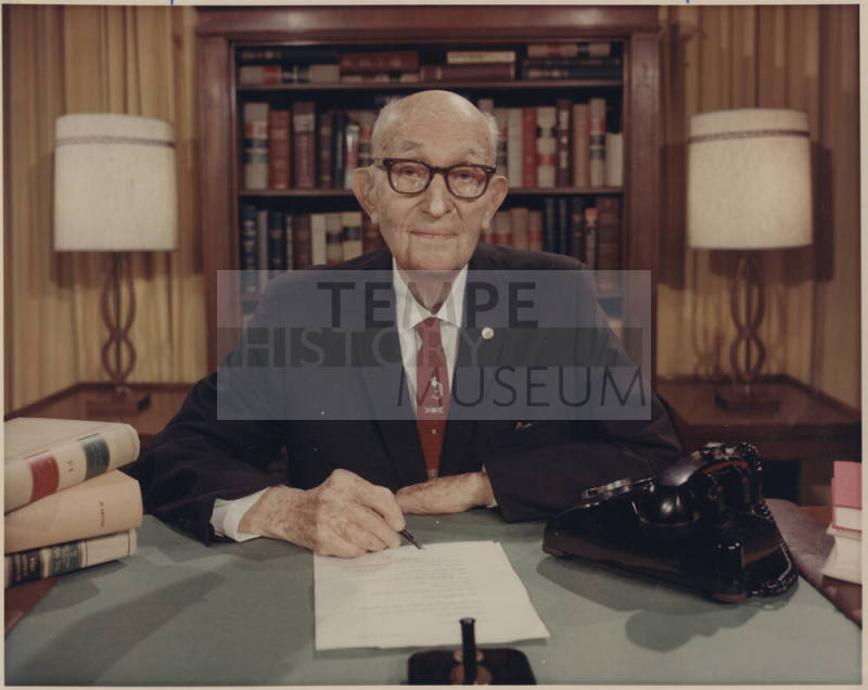 Senator Hayden seated behind office desk
