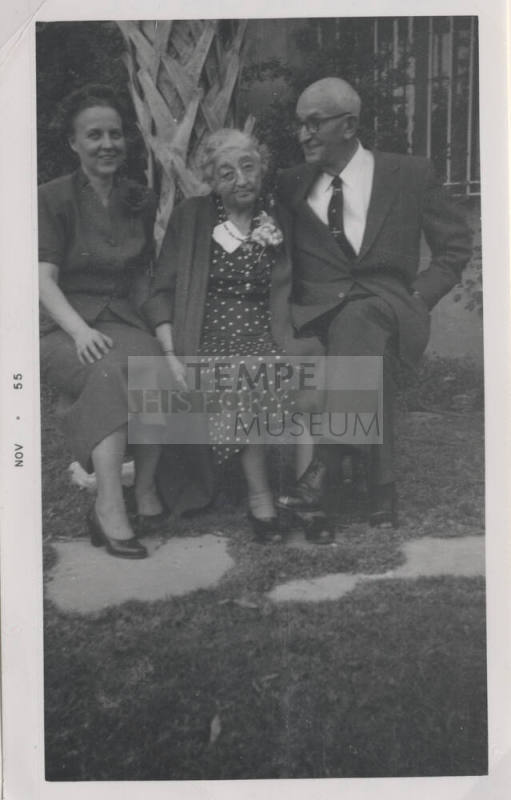 Dolly, Nan, and Carl Hayden seated on a Bench by a Palm Tree