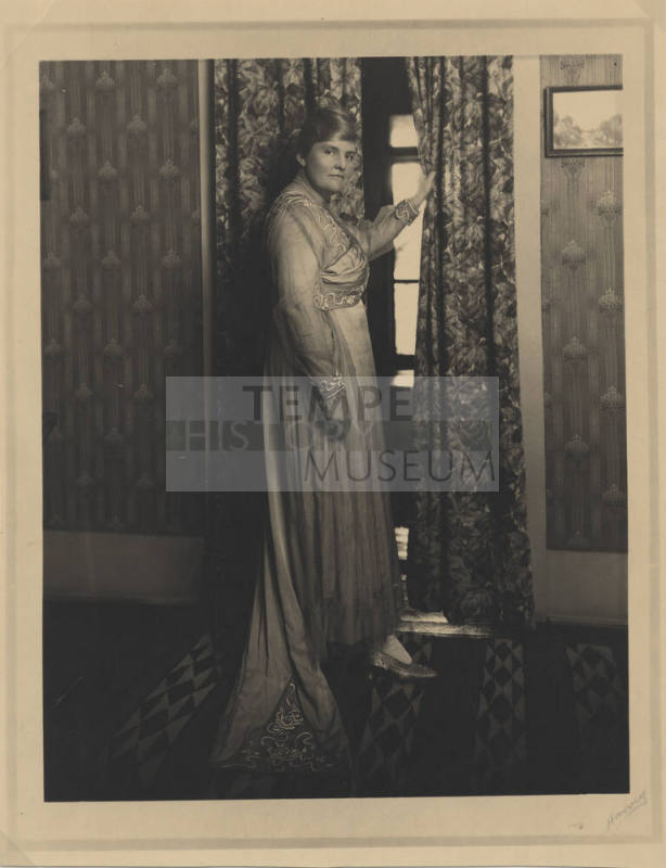 Woman in Traditional Garb in Room with Historic Decor