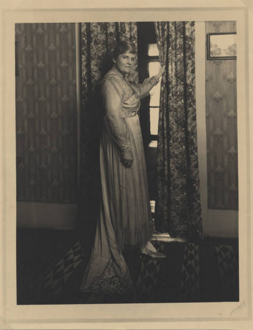 Woman in Traditional Garb in Room with Historic Decor