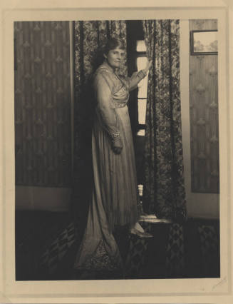 Woman in Traditional Garb in Room with Historic Decor