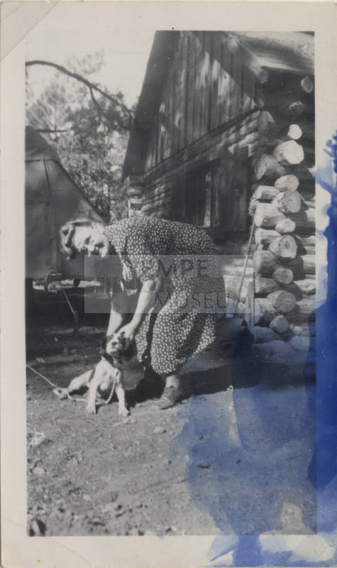 Sallie Hayden and a dog at a cabin