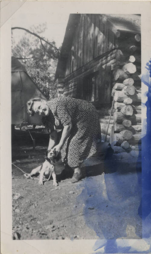 Sallie Hayden and a dog at a cabin