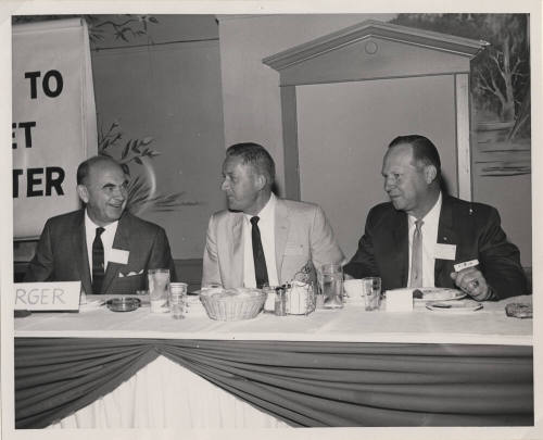 Larry Hayden and Two other Men at the Head Table of an Event