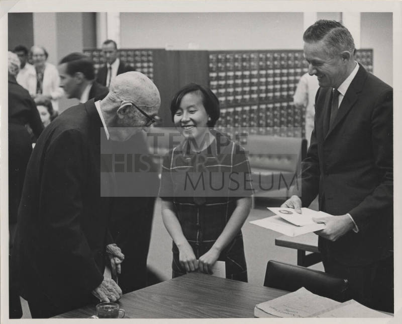 Carl Hayden speaks to a woman inside the C. T. Hayden Library at the convocation.