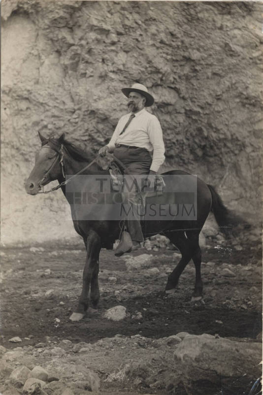 Dr. Fenn Hart Riding a Dark Horse